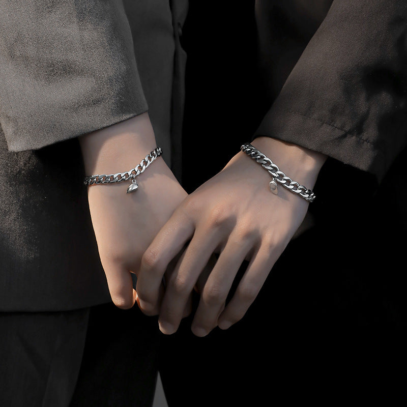 Two people wearing the Matching Hearts bracelets